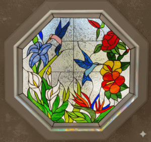 An octagonal leaded stained glass window depicting a vibrant tropical floral scene with two blue hummingbirds, white calla lilies, red hibiscus, orange bird of paradise, and a blue iris, set against a textured clear privacy glass background within a white frame.