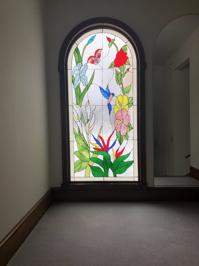 Arched top Stained Glas Window installed in a Bedroom
