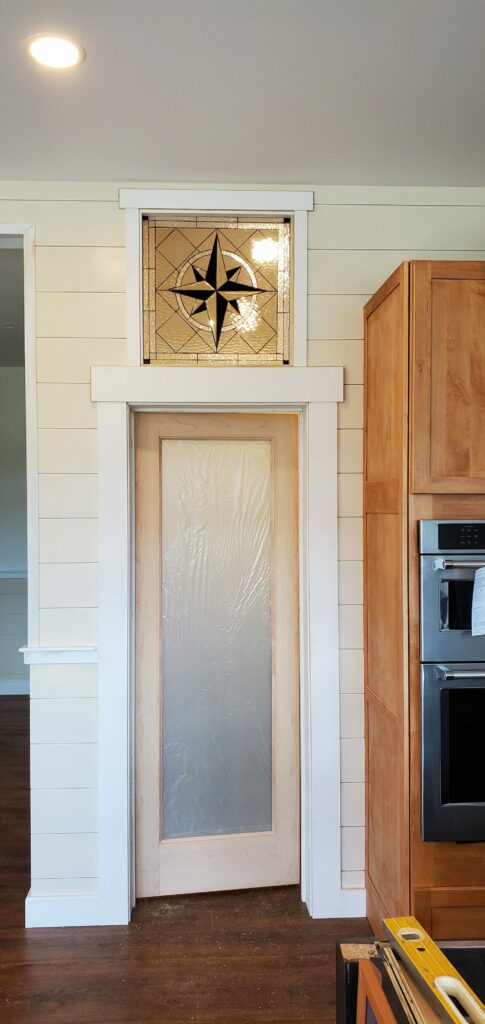 Compass rose with clear beveled and black glass between 2 rooms
