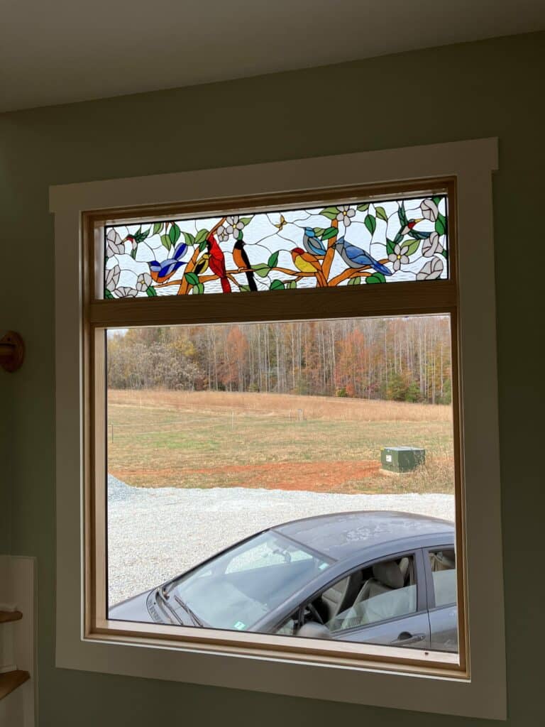 Colorful Bird Gathering stained glass for transom window