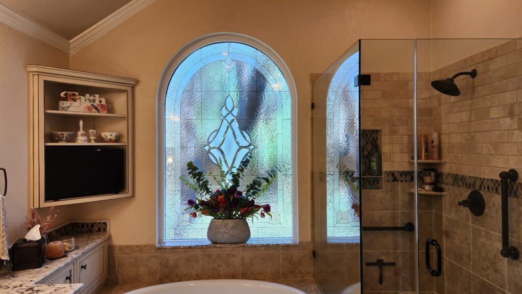 Arched top clear and beveled Stained Glass Installed over a Bathub