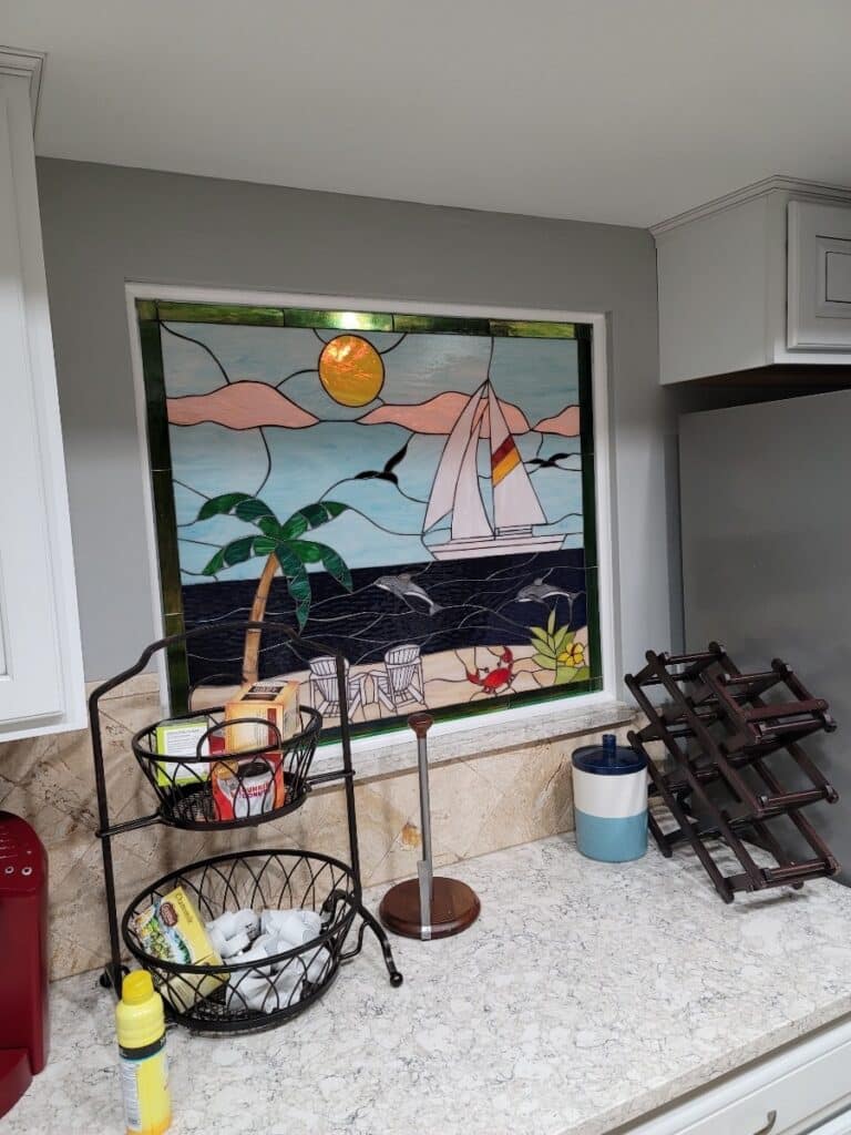 Sailboat, dolphins, and beach Stained Glass Installed