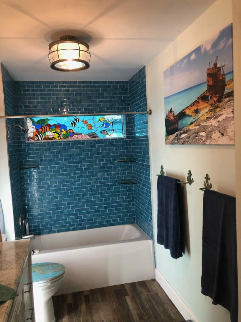 Shower window featuring a Stained Glass Scene of a colorful Coral reef with Fish.