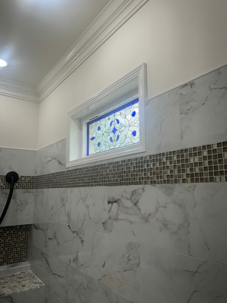 Beveled Glass Window with Blue Accents Installed in a Shower
