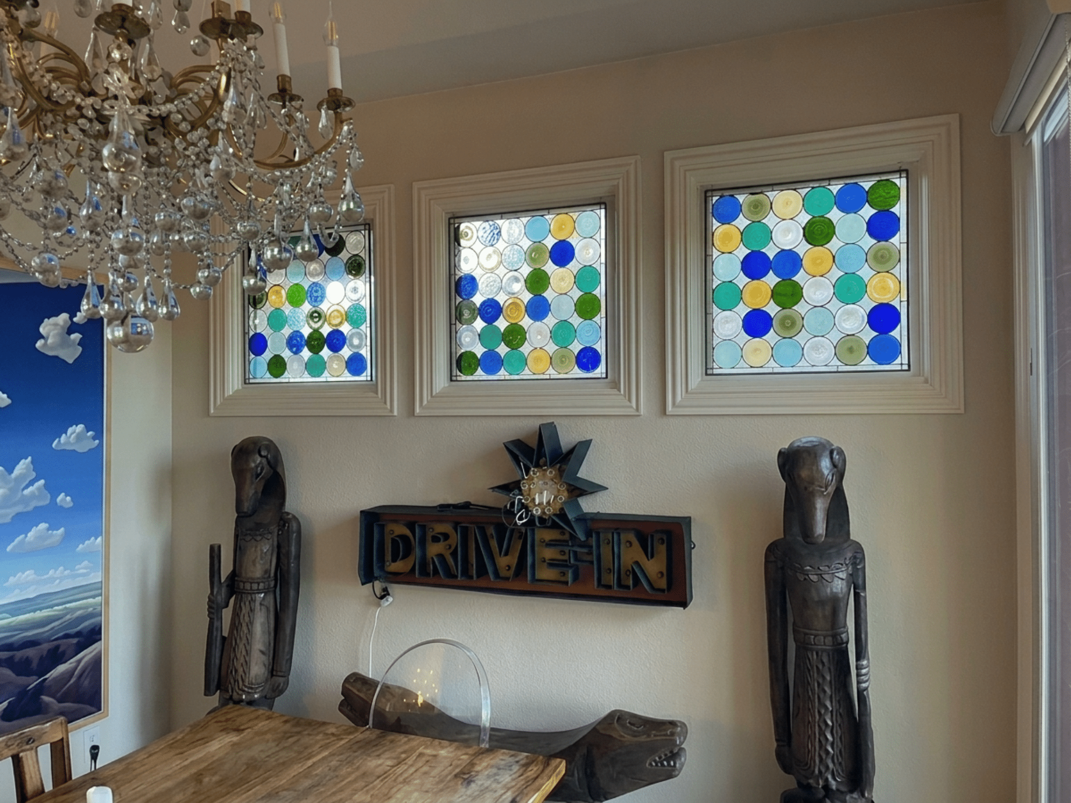 Three rectangular leaded stained glass panels, each featuring a grid of colorful circular glass pieces in blue, green, yellow, and clear hues.