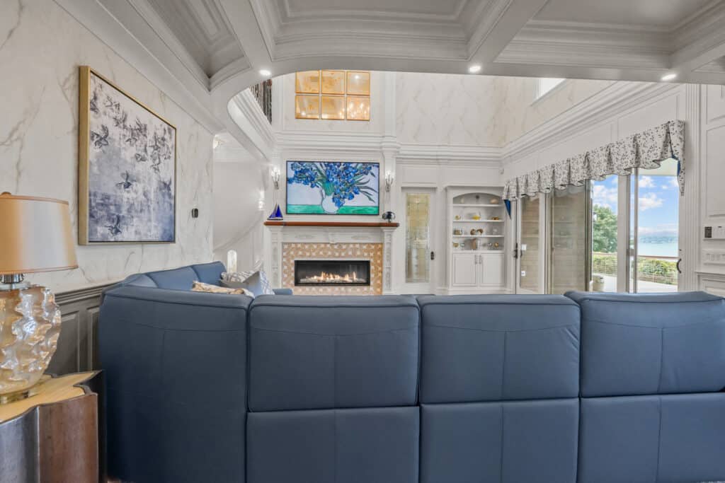 A tall, narrow, rectangular leaded glass panel featuring clear textured and beveled glass designs, integrated into a white architectural frame beside a built-in cabinet.