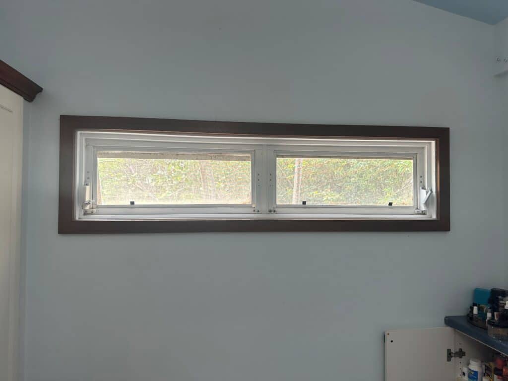 A horizontal rectangular leaded stained glass transom panel featuring clear textured and beveled glass in a subtle geometric pattern.