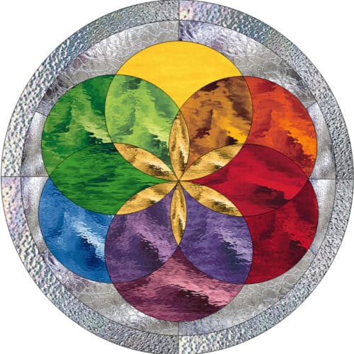 A circular leaded stained glass panel featuring a central geometric Flower of Life design in vibrant rainbow colors, surrounded by concentric rings of clear textured glass.